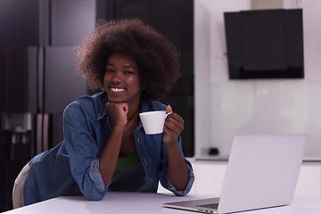 Image showing smiling black woman in modern kitchen