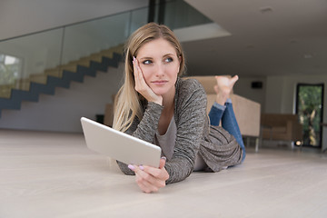 Image showing young women used tablet computer on the floor