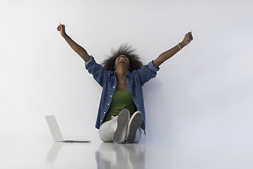 Image showing african american woman sitting on floor with laptop