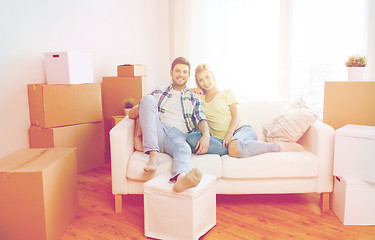 Image showing happy couple with big cardboard boxes at new home