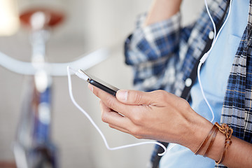 Image showing man with earphones and smartphone listening music