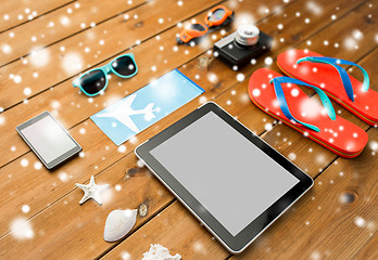 Image showing tablet pc, airplane ticket and beach stuff