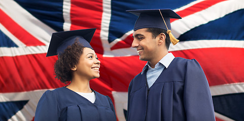 Image showing happy students or bachelors in mortar boards