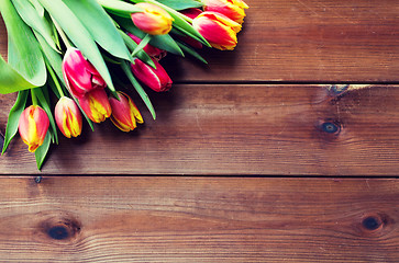 Image showing close up of tulip flowers on wooden table
