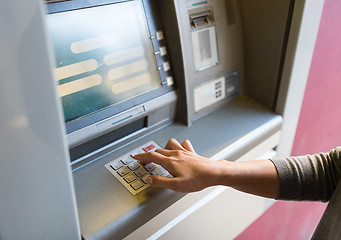 Image showing close up of hand entering pin code at atm machine