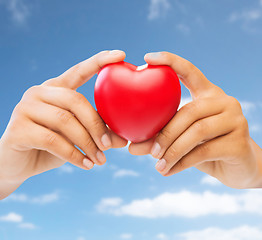 Image showing close up of woman hands with red heart