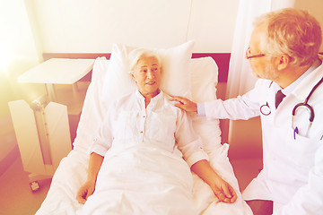 Image showing doctor visiting senior woman at hospital ward