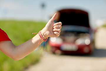 Image showing woman with broken car hitching at countryside