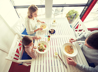 Image showing happy family having dinner at restaurant or cafe
