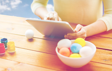 Image showing close up of woman with tablet pc and easter eggs