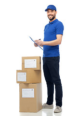 Image showing happy delivery man with parcel boxes and clipboard