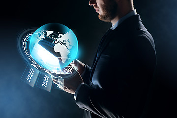 Image showing businessman with tablet pc and earth hologram