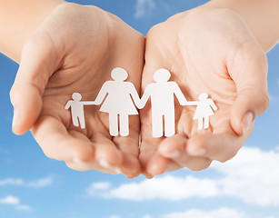 Image showing close up of hands holding paper family pictogram