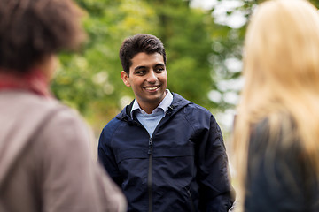 Image showing happy friends walking along autumn park