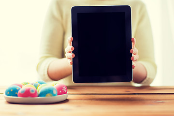 Image showing close up of woman with tablet pc and easter eggs