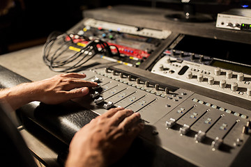 Image showing man using mixing console in music recording studio