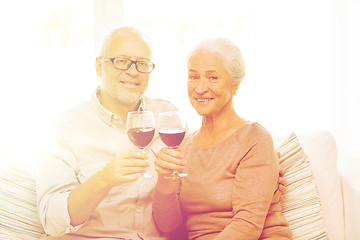 Image showing happy senior couple with glasses of red wine