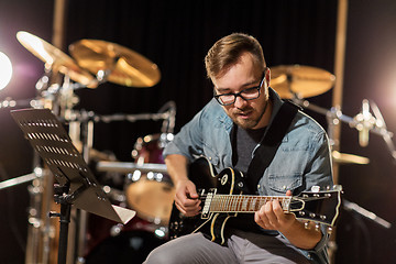 Image showing man playing guitar at studio rehearsal