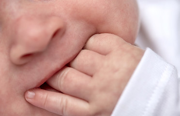 Image showing close up of baby sucking his fingers