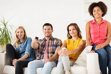 Image showing happy friends with remote watching tv at home