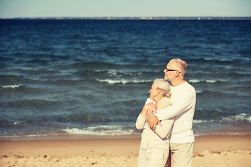 Image showing happy senior couple hugging on summer beach