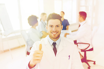 Image showing happy doctor over group of medics at hospital