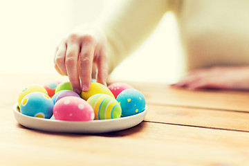 Image showing close up of woman hands with colored easter eggs