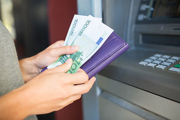 Image showing close up of hand withdrawing money at atm machine