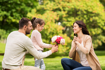 Image showing happy family with flowers in summer park