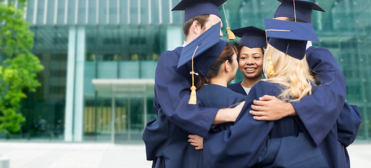 Image showing happy students or bachelors hugging