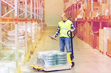 Image showing man with loader and clipboard at warehouse