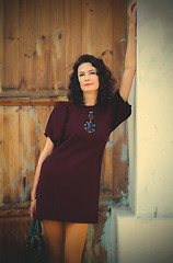 Image showing beautiful woman in a fashionable burgundy dress