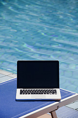 Image showing Laptop computer near swimming pool 