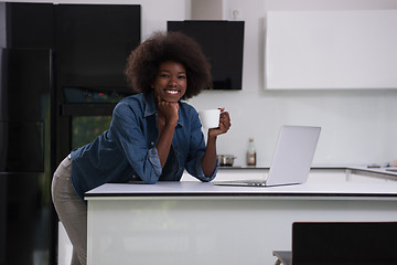 Image showing smiling black woman in modern kitchen