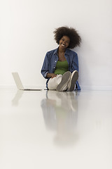 Image showing african american woman sitting on floor with laptop