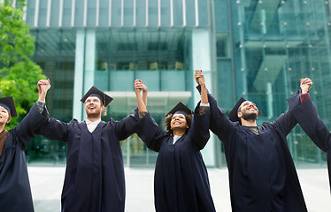 Image showing happy students or bachelors celebrating graduation