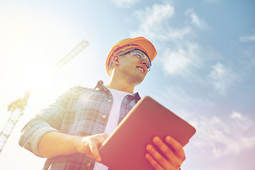 Image showing builder in hardhat with tablet pc at construction