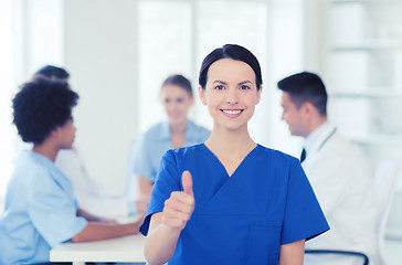 Image showing happy doctor over group of medics at hospital