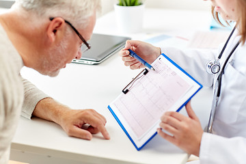 Image showing doctor showing cardiogram to old man at hospital