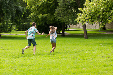 Image showing group of happy kids or friends playing outdoors