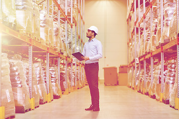 Image showing happy businessman with clipboard at warehouse