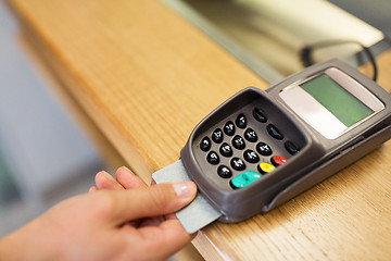 Image showing close up of hand inserting bank card to terminal