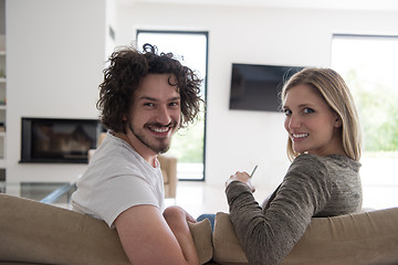 Image showing Rear view of couple watching television