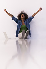 Image showing african american woman sitting on floor with laptop