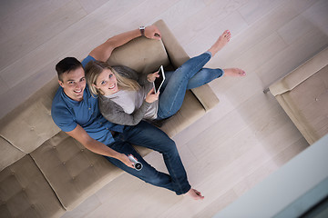 Image showing youg couple in living room with tablet top view