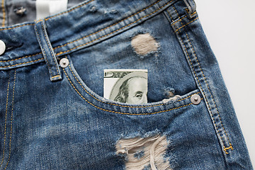 Image showing dollar money in pocket of denim pants or jeans