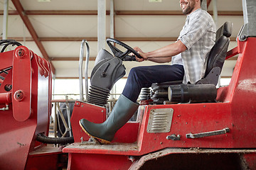 Image showing man or farmer driving tractor at farm