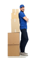 Image showing happy delivery man with parcel boxes