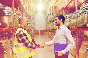 Image showing worker and businessmen with clipboard at warehouse