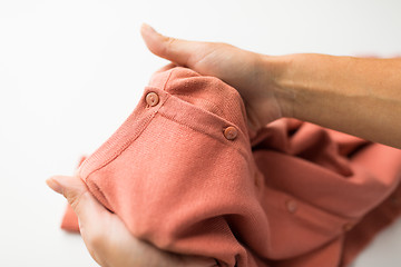 Image showing close up of hands with clothing item or cardigan